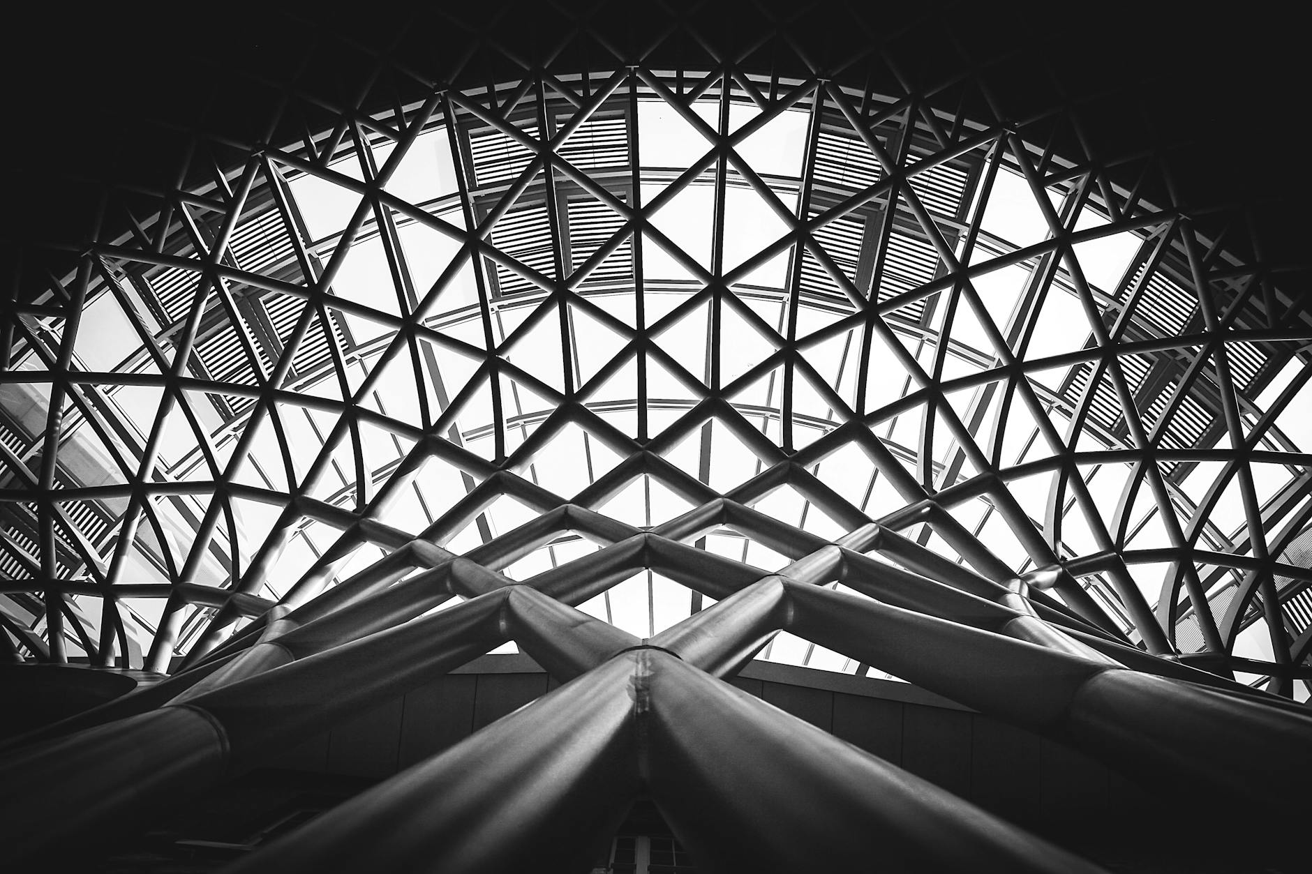 low angle photography of metal building on grayscale