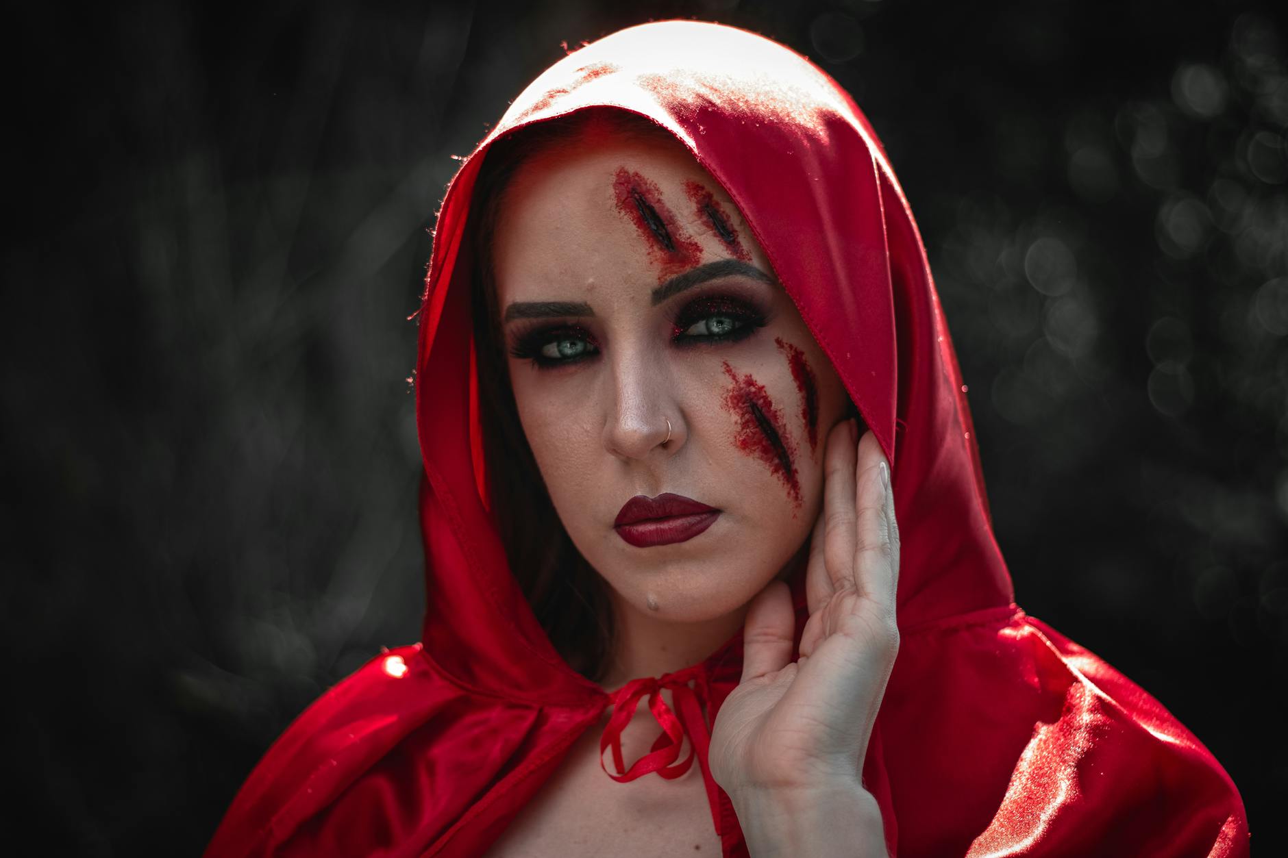 woman wearing red hood with makeup